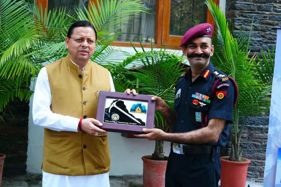 CM Pushkar Singh Dhami receiving a memento from an Indian Army officer during the NIM mountaineering flag-in ceremony